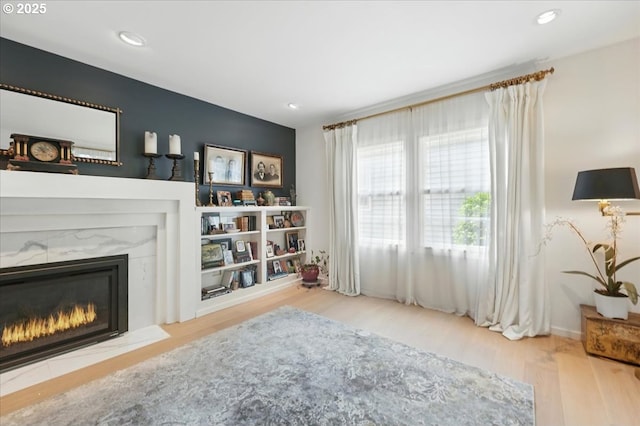 7338 N Chase Ave, Portland, OR 97217 - living area with a fireplace, wood finished floors, and recessed lighting