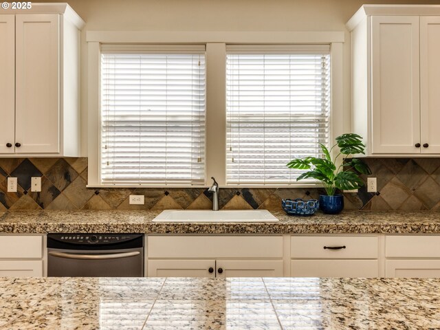 7760 SW Hyland Way, Beaverton, OR 97008 - kitchen featuring a sink, stainless steel dishwasher, white cabinetry, and tasteful backsplash