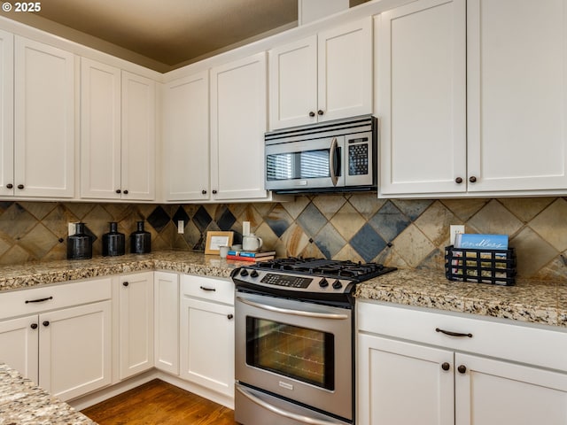 7760 SW Hyland Way, Beaverton, OR 97008 - kitchen featuring stainless steel appliances, white cabinets, and tasteful backsplash