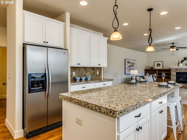 7760 SW Hyland Way, Beaverton, OR 97008 - kitchen featuring stainless steel refrigerator with ice dispenser, wood finished floors, a kitchen island, ceiling fan, and open floor plan