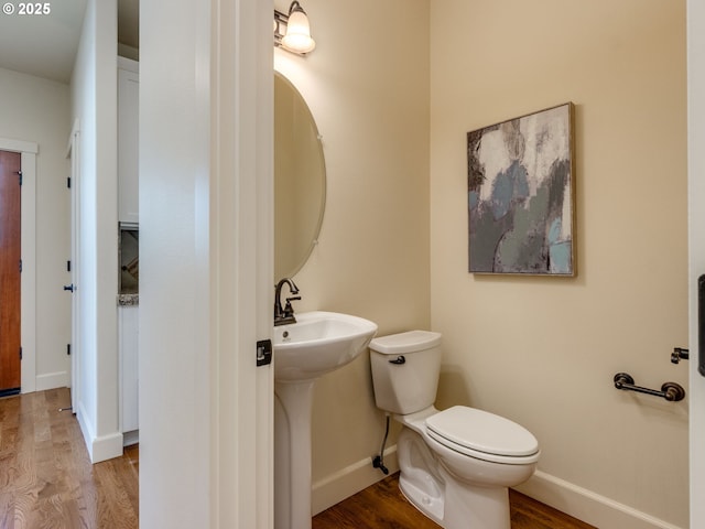 7760 SW Hyland Way, Beaverton, OR 97008 - half bathroom with wood finished floors, toilet, baseboards, and a sink