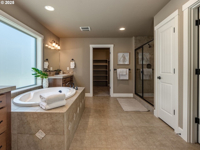 7760 SW Hyland Way, Beaverton, OR 97008 - bathroom with a shower stall, vanity, a bath, a walk in closet, and recessed lighting