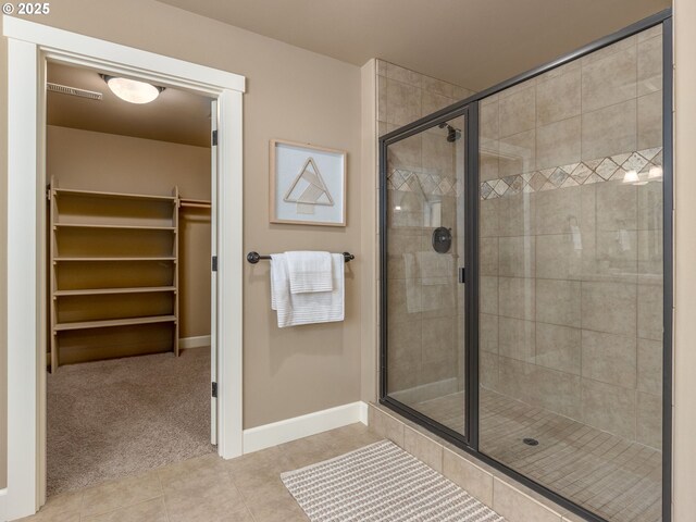 7760 SW Hyland Way, Beaverton, OR 97008 - bathroom with a stall shower, tile patterned floors, a spacious closet, and baseboards