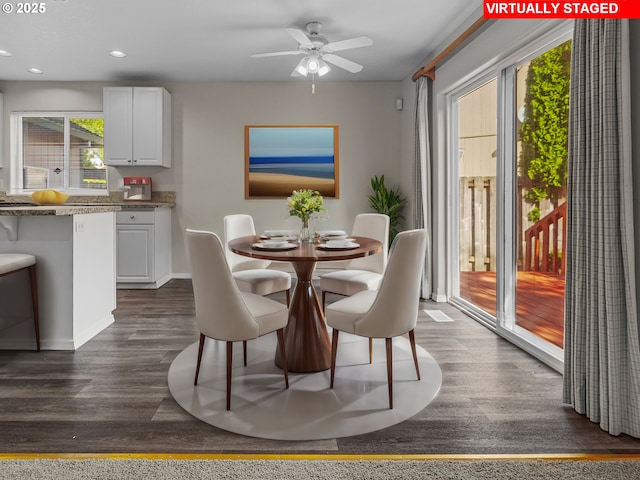 dining room with dark hardwood / wood-style flooring and ceiling fan