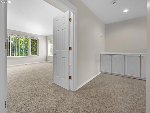 corridor with light colored carpet