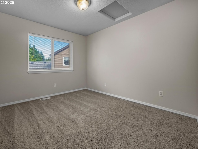 carpeted empty room with a textured ceiling