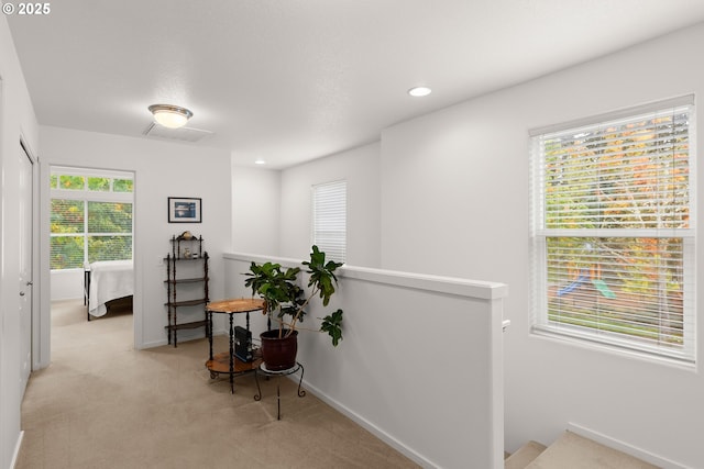 sitting room with an upstairs landing, carpet floors, baseboards, and recessed lighting