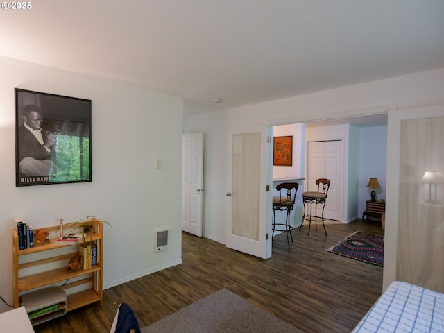living area featuring baseboards, wood finished floors, and french doors