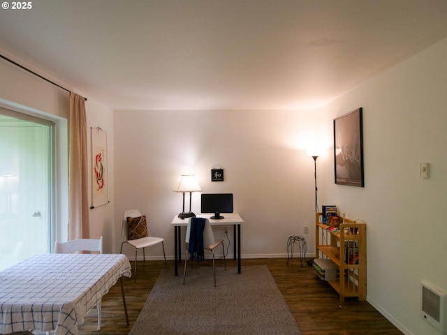 living area featuring baseboards, wood finished floors, and visible vents