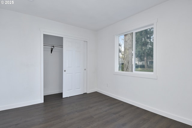 2718 SE 138th Ave Unit 64, Portland, OR 97236 - unfurnished bedroom featuring baseboards, dark wood-style floors, and a closet