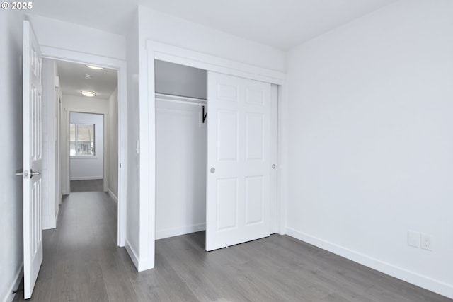 2718 SE 138th Ave Unit 64, Portland, OR 97236 - unfurnished bedroom featuring dark wood-style floors, baseboards, and a closet