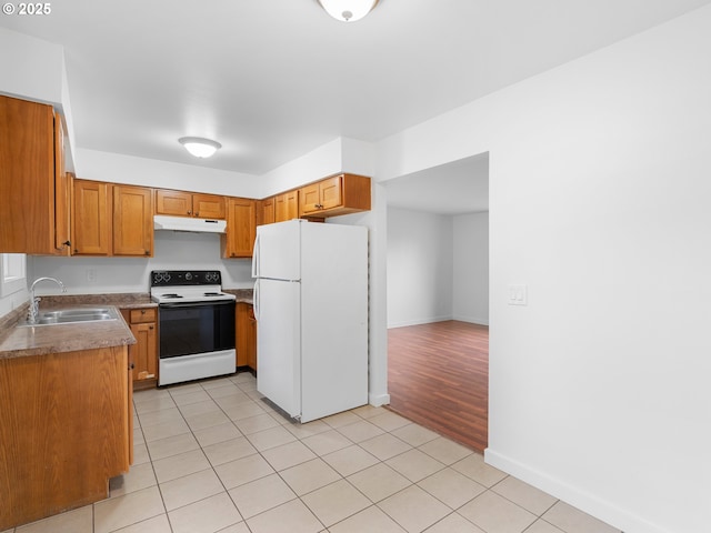 kitchen featuring sink, white appliances, and light tile patterned floors