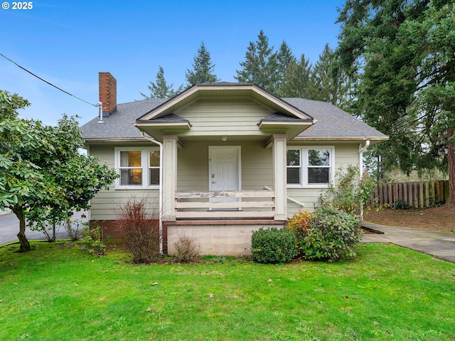 bungalow-style house featuring a porch and a front lawn