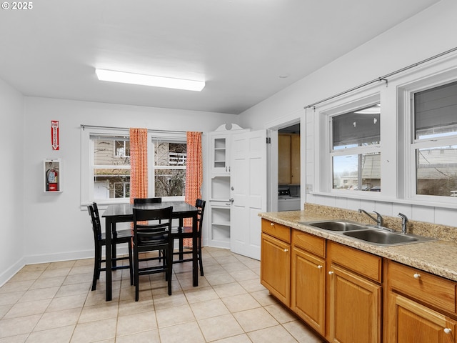 kitchen featuring sink, light tile patterned flooring, and plenty of natural light