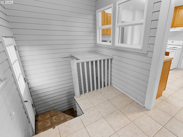 interior space featuring wood walls and tile patterned floors