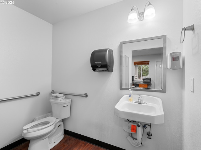 bathroom with wood-type flooring, sink, and toilet