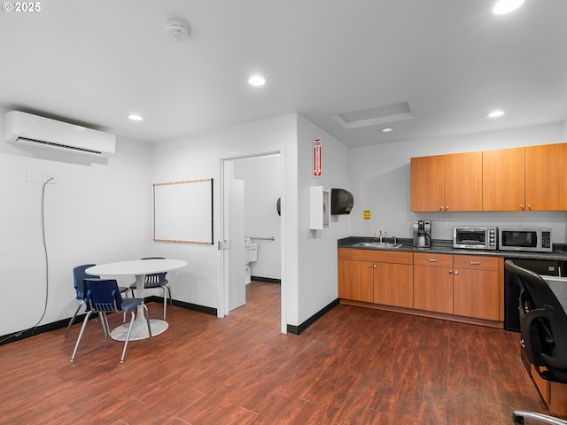 kitchen featuring sink, dark wood-type flooring, and a wall unit AC