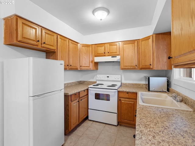 kitchen featuring white appliances, light tile patterned floors, and sink