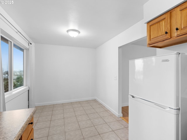 kitchen featuring white fridge and light tile patterned floors