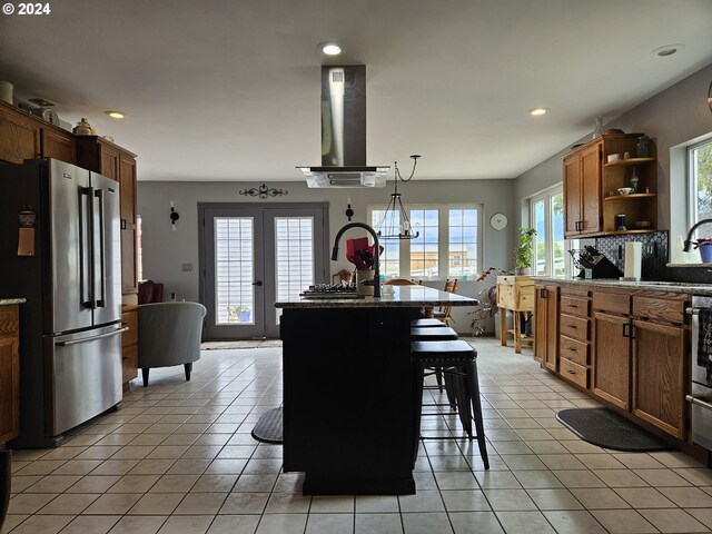 42139 Dry Gulch Rd, Richland, OR 97870 - kitchen with freestanding refrigerator, wall chimney exhaust hood, healthy amount of natural light, open shelves, and recessed lighting