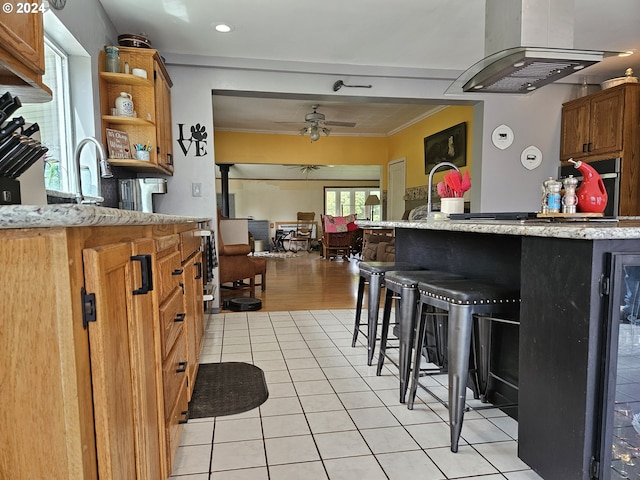 kitchen featuring light tile patterned floors, ceiling fan, exhaust hood, open shelves, and crown molding