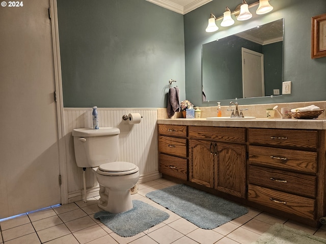 bathroom featuring wainscoting, toilet, ornamental molding, tile patterned flooring, and vanity