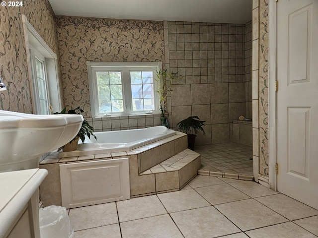 full bath with wallpapered walls, a bath, and tile patterned floors