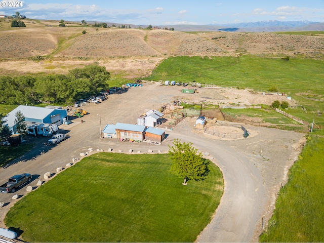 birds eye view of property with a rural view