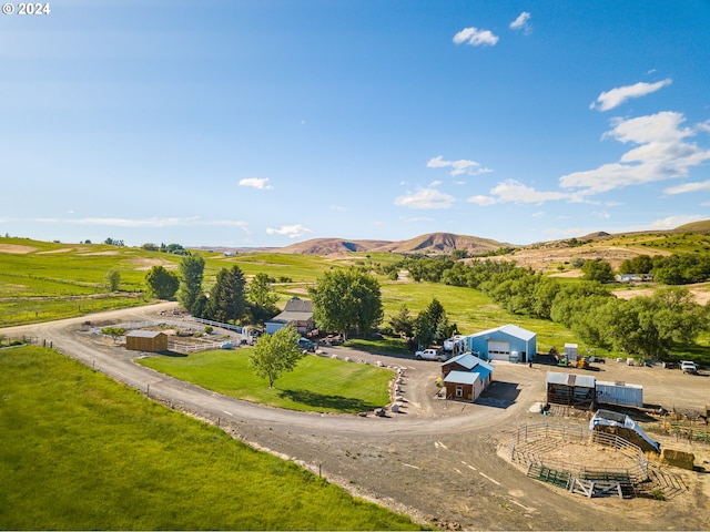 drone / aerial view featuring a mountain view and a rural view