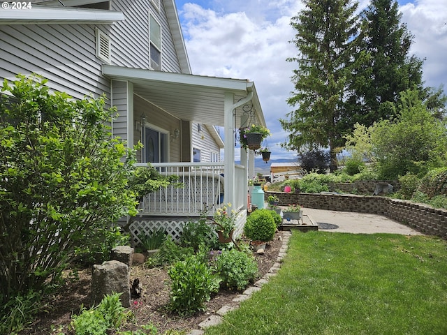 view of yard with covered porch and a patio area