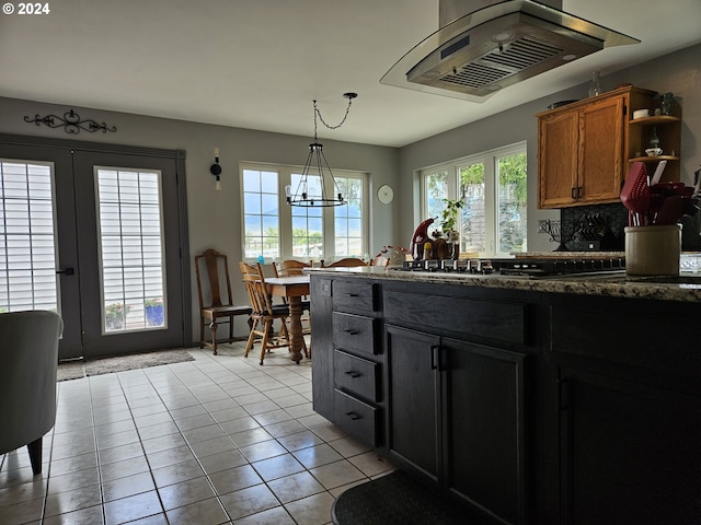 kitchen with hanging light fixtures, island exhaust hood, a chandelier, open shelves, and light tile patterned flooring