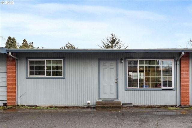 view of front of home with entry steps and brick siding