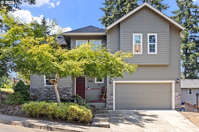 952 S 69th St, Springfield, OR 97478 - view of front of property with a garage, stone siding, and driveway