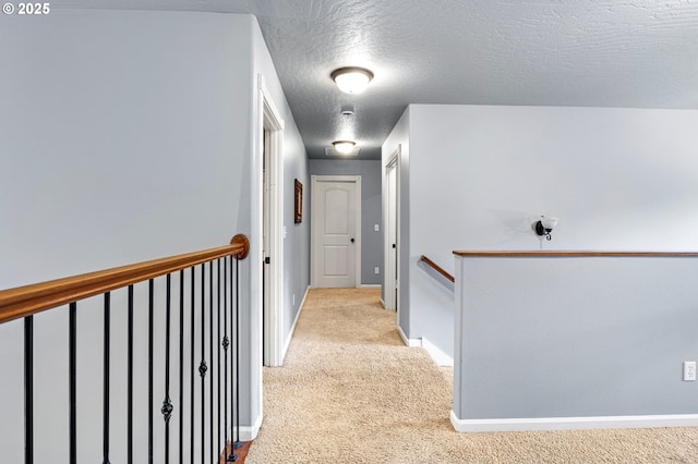 952 S 69th St, Springfield, OR 97478 - hallway featuring an upstairs landing, light colored carpet, and a textured ceiling