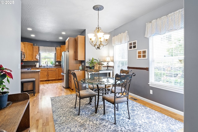 952 S 69th St, Springfield, OR 97478 - dining space with a chandelier and light wood-type flooring