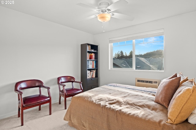 bedroom featuring ceiling fan, light colored carpet, and a wall unit AC