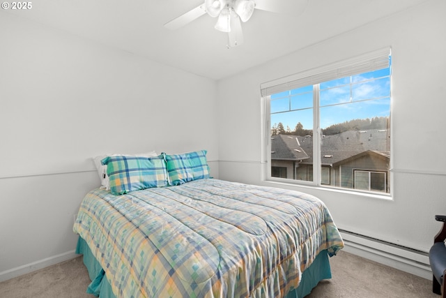 bedroom featuring ceiling fan, light colored carpet, and a baseboard heating unit