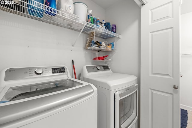 laundry area with washing machine and clothes dryer