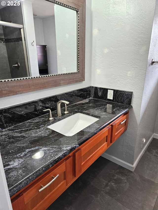 625 Crestview Dr, Reedsport, OR 97467 - full bath with vanity, a textured wall, a stall shower, and baseboards