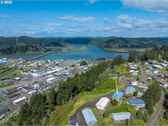 625 Crestview Dr, Reedsport, OR 97467 - aerial overview of property's location with a water and mountain view, a forest, and nearby suburban area