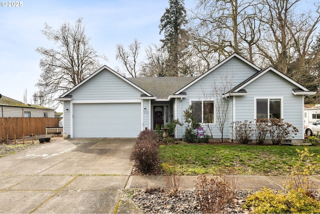 ranch-style home featuring an attached garage, fence, concrete driveway, and a front yard