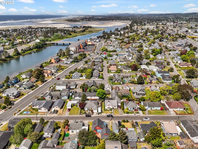 aerial overview of property's location with a large body of water and nearby suburban area