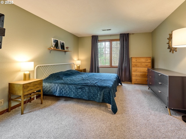 bedroom with light colored carpet and visible vents