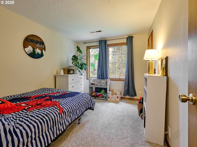 carpeted bedroom with visible vents and a textured ceiling