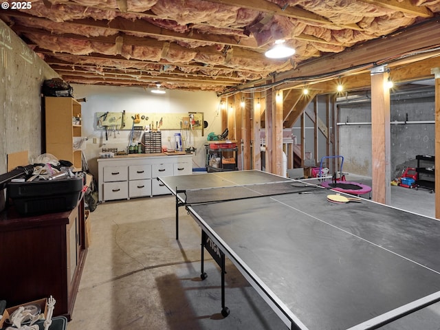 game room featuring concrete floors and a workshop area