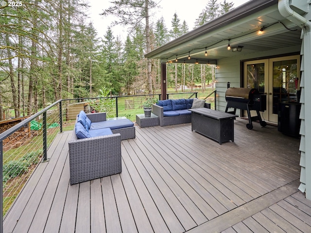 wooden terrace featuring french doors, outdoor lounge area, and a grill