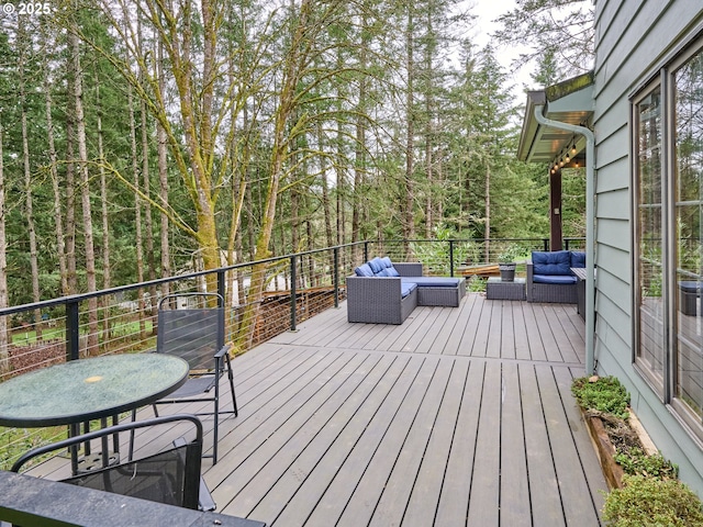 wooden deck featuring outdoor dining space and an outdoor living space