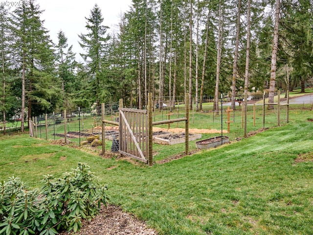 view of yard with a garden and fence