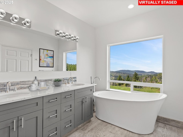 1091 N Echo Mountain Rd, Otis, OR 97368 - bathroom featuring a mountain view, double vanity, a soaking tub, and recessed lighting