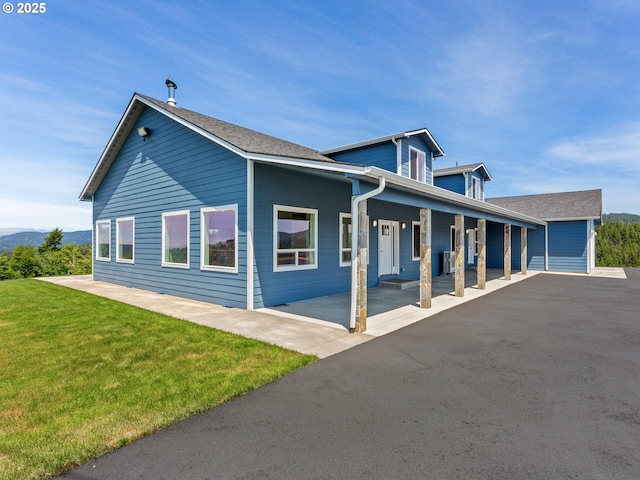 1091 N Echo Mountain Rd, Otis, OR 97368 - view of property exterior with a porch and a yard